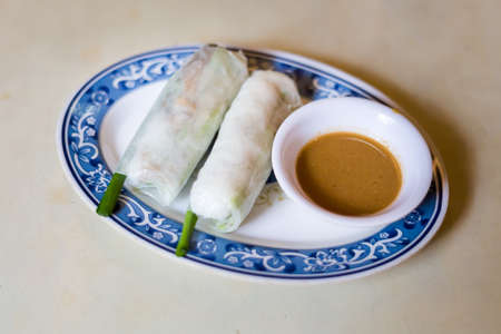 Delicious colorful local food in vegan restaurant: Goi Cuon fresh springroll. Traditional vietnamese...