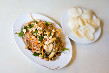 Delicious colorful local food in vegan restaurant - banana leaf salad with peanuts. Traditional vietnamese cuisine in Ho Chi Minh, Vietnam.の写真素材