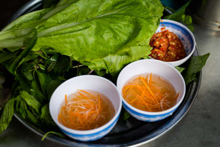 Delicious colorful local food banh xeo - crispy pancakes with shrimps on the market. Traditional...