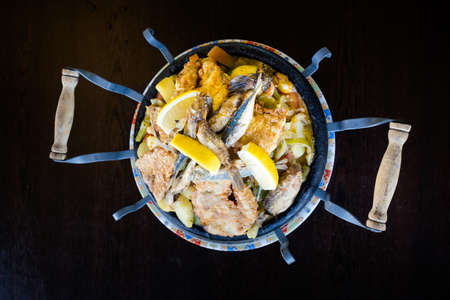 Delicious colorful local food in a restaurant. Traditional bulgarian Sac seafood plate in Bulgaria.の写真素材