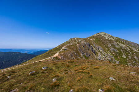 Beautiful path around Chopok and Dumbier mountain with Stefanika shelter - in slovakian low Tatra mountains. Summer panorama with great weather and blue skyの写真素材