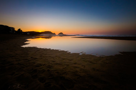 Beautiful sunrise on Zipolite beach in Mexico. Landscape with golden sunの写真素材