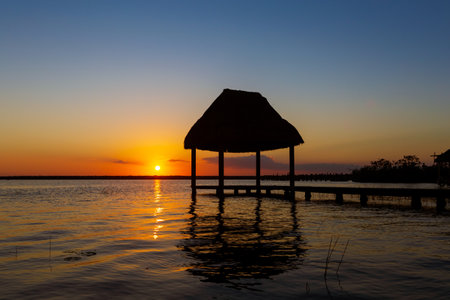 Beautiful sunrise landscape photo taken in Laguna Bacalar in Mexico during kayak trip.の写真素材