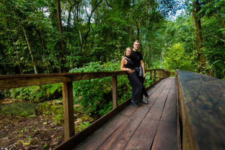 Beautiful young tourists couple in Agua Azul cascades park in Palenque, Mexico. Vivid landscape photo.の写真素材