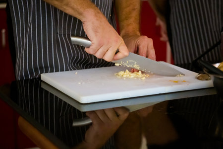 Traditional way of preparing indian food using chopper knife. Picture of traditional India cuisine made of fresh ingredients taken during cooking class in Goaの写真素材