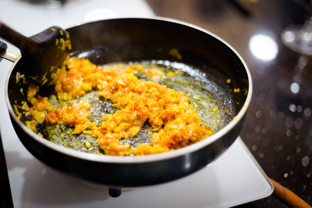Traditional way of preparing indian food mushroom curry using gas pan. Picture of traditional India cuisine made of fresh ingredients taken during cooking class in Goaの写真素材