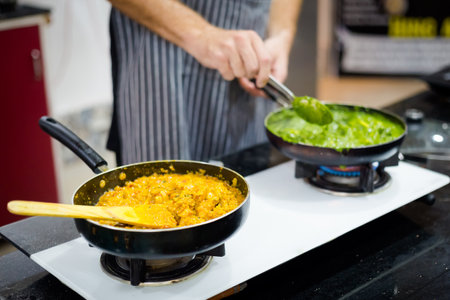 Traditional way of preparing indian food using gas pan. Picture of traditional India cuisine made of fresh ingredients taken during cooking class in Goaの写真素材