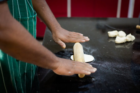 Traditional way of preparing indian food, making roti bread. Picture of traditional India cuisine made of fresh ingredients taken during cooking class in Goa.の写真素材