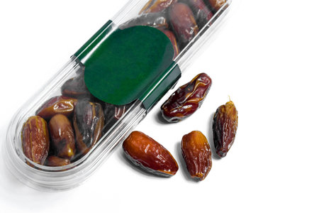 Dates fruit in plastick package with blank green label for product mockup design, dates product isolated white backgroundの写真素材
