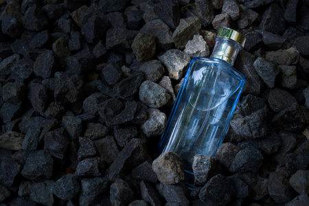 Blue transparent bottle in gravel or coral backgroundの写真素材