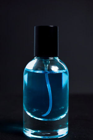 Transparent Blue Bottle Perfume isolated black background for mock up designの写真素材