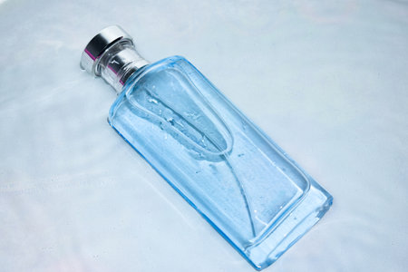 Blue Bottle Perfume in water splash background with Top angle View.の写真素材