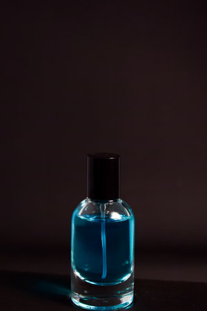 Transparent Blue Bottle Perfume isolated black background for mock up designの写真素材