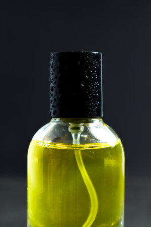 Transparent Yellow Bottle Perfume isolated black background for mock up design