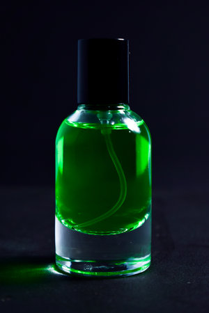 Transparent Dark green Bottle Perfume isolated black background for mock up design