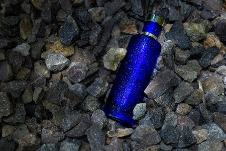 Transparent bottle in gravel or coral backgroundの写真素材