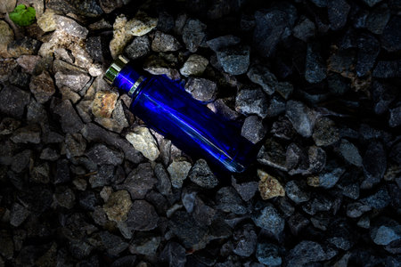Transparent bottle in gravel or coral backgroundの写真素材