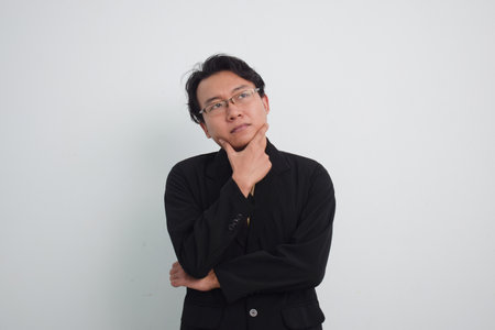 Thoughtful asian businessman with currious face think about solution in isolated white background