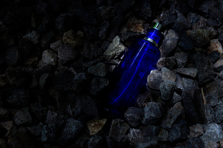 Transparent bottle in gravel or coral backgroundの写真素材