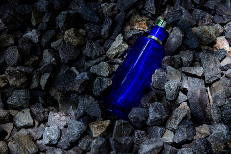Transparent bottle in gravel or coral backgroundの写真素材