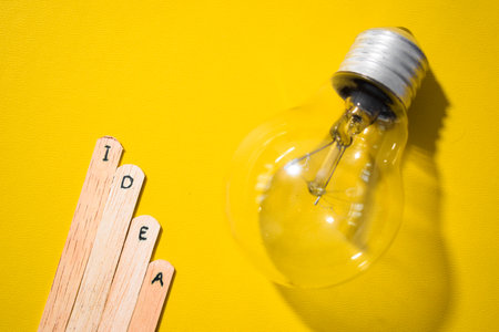 stick of ice cream with the words Idea and lightbulb. Motivational quotes, optimism, positive words. Isolated on backgroundの写真素材