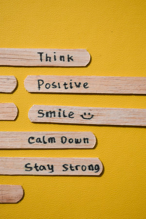 stick of ice cream with the words Think Positive, Smile, calm dowm, Stay strong. Motivational quotes, optimism, positive words. Isolated on backgroundの写真素材