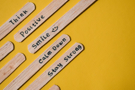 stick of ice cream with the words Think Positive, Smile, calm dowm, Stay strong. Motivational quotes, optimism, positive words. Isolated on backgroundの写真素材