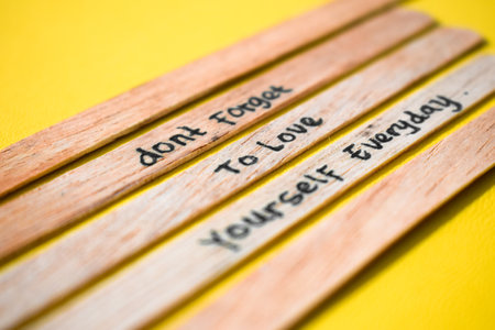 stick of ice cream with the words don't forget to love yourself everyday. Motivational quotes, optimism, positive words. Isolated on backgroundの写真素材