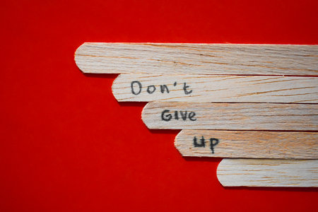 stick of ice cream with the words Never Give Up. Motivational quotes, optimism, positive words. Isolated on backgroundの写真素材