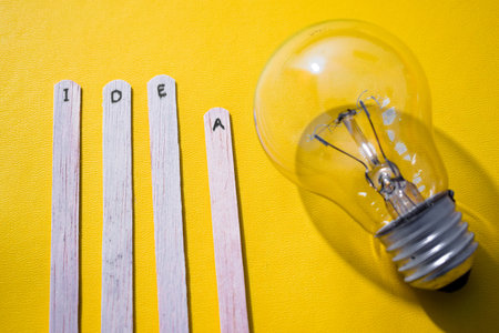 stick with the words Idea and lightbulb. Motivational quotes, optimism, positive words. Isolated on backgroundの写真素材