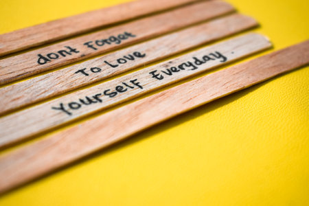 stick of ice cream with the words don't forget to love yourself everyday. Motivational quotes, optimism, positive words. Isolated on backgroundの写真素材