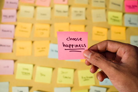 Hand hold sticky notes with words Choose Happiness. Motivational words for personal development,...