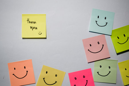 Thank you and smile emoticon on sticky notes. Motivational words for personal development, inspirational handwriting.の写真素材