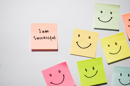 I am successful and smile emoticon on sticky notes. Motivational for personal development,...