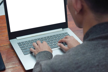 Close up top view employee working remote at home in living room, typing laptop due job deadlineの写真素材