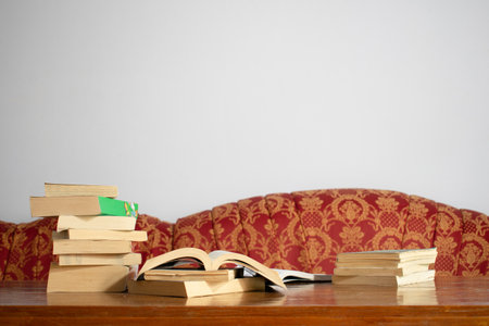 Background book on table and red sofa with white wall in living roomの写真素材