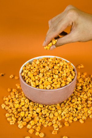 Traditional snack from Indonesia. Made from corn kernels that are fried. Fried corn in a bowl with an isolated backgroundの写真素材