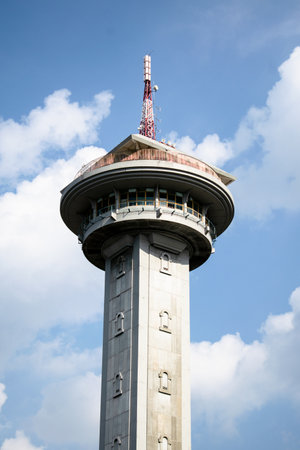 Tower Monument with antenna on top, cloudy blue sky as background