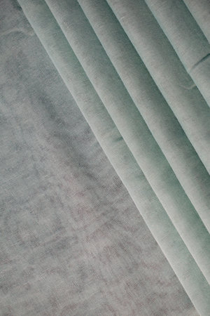 Green fabric folded background textureの写真素材
