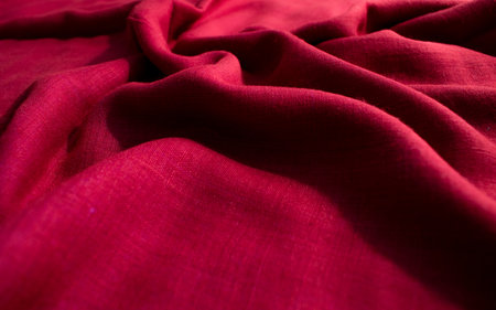 CLose up Red fabric wavy crumpled background texture.の写真素材