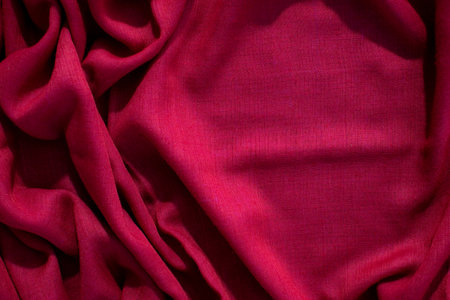 Red fabric wavy crumpled background texture with copy space.の写真素材