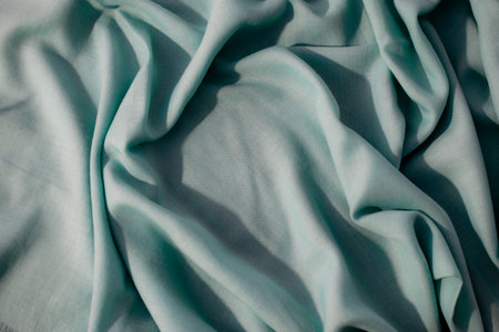 Nude green fabric wavy crumpled background texture with copy space.の写真素材