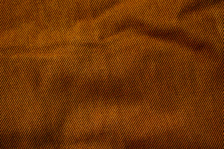 Detailed bright brown jeans fabric background texture.