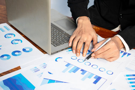 Businessman pointing graphic chart with pen. Financial, account, statistics and business data concept.の写真素材