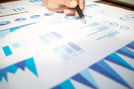 Close up businessman hand pointing graphic chart with pen. Financial, account, statistics and business data concept.の写真素材