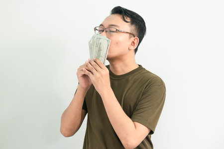 Happy asian man holding money. Banking, Financial isolated, green color concept.