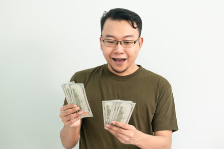 Happy asian man counting Money. Banking, Financial isolated, green color concept.