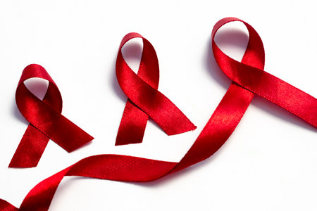 Red ribbons, HIV awareness concept, world AIDS day, world hypertension day, world cancer day with copy space over white background.の写真素材