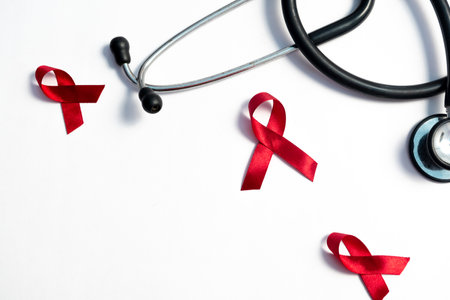 Red ribbon and stethoscope, HIV awareness concept, world AIDS day, world cancer day isolated white background.の写真素材