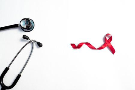 Red ribbon and stethoscope, HIV awareness concept, world AIDS day, world cancer day isolated white...
